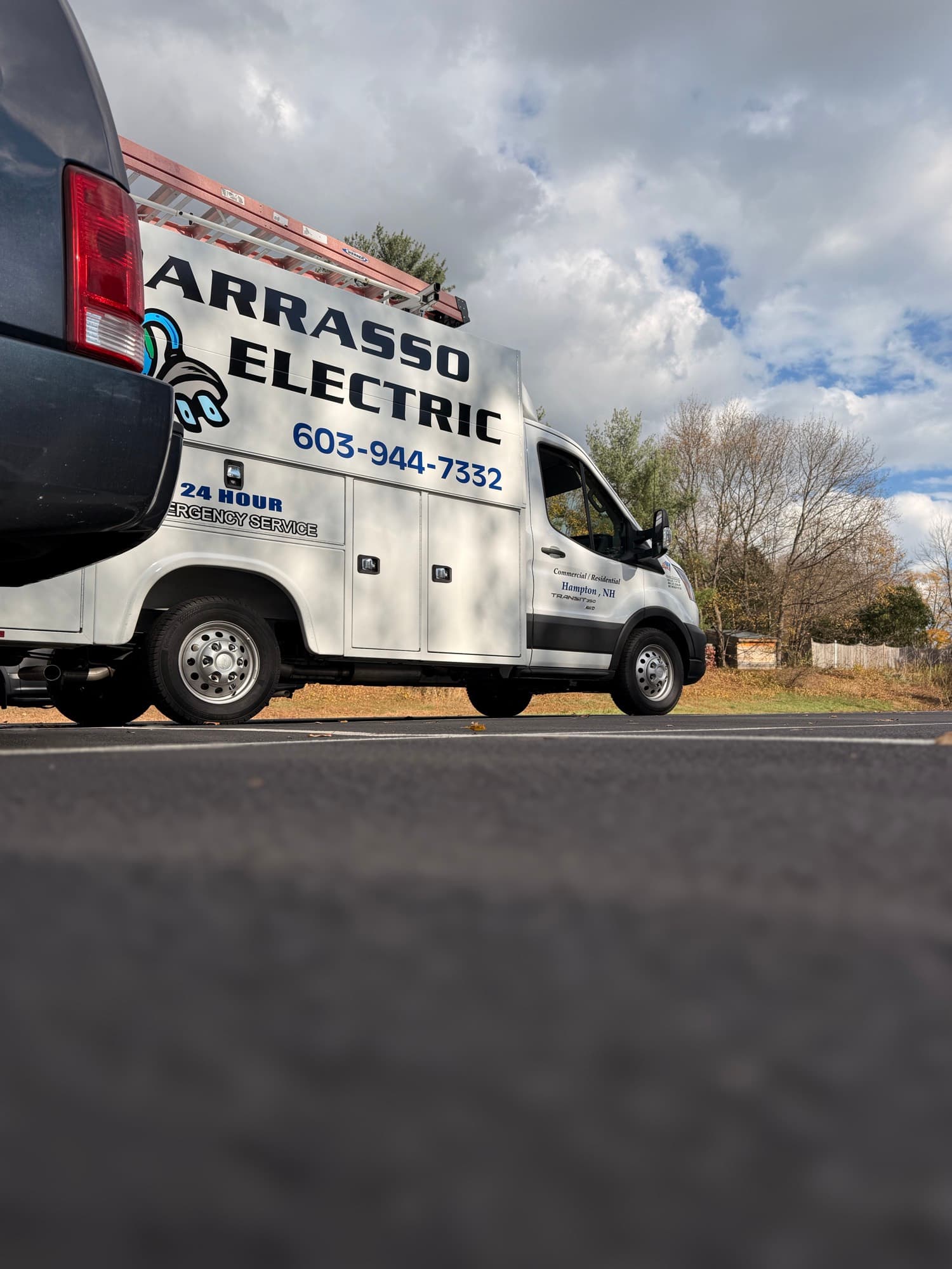 The lettered side of the Barrasso Electric van, ladder racked overhead