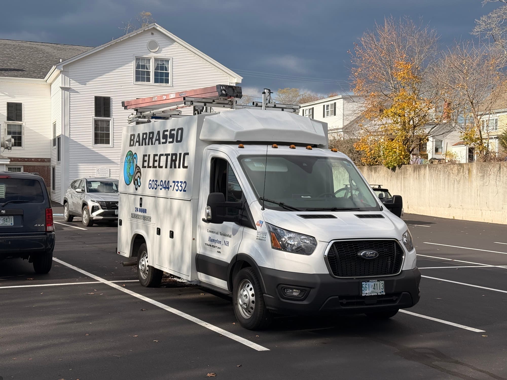 The Barrasso Electric service van, ladders on the roof rack, parked in Hampton under a dark autumn sky
